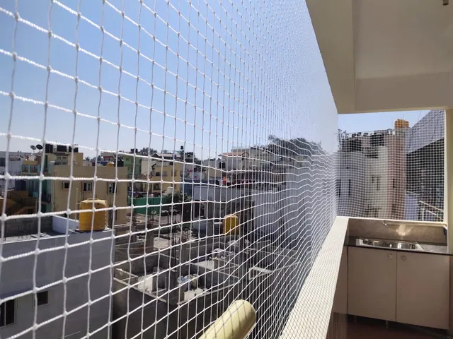 Balcony safety net installation in progress on a Hyderabad apartment